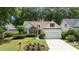 Charming single-Gathering home featuring a stone accent wall, red shutters, well-manicured lawn and two-car garage at 77 Redwing Ct., Pawleys Island, SC 29585