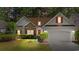 Charming single-Gathering home featuring a stone accent wall, red shutters, well-manicured lawn and two-car garage at 77 Redwing Ct., Pawleys Island, SC 29585