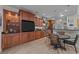 Well-appointed kitchen with dark wood cabinets, stainless steel appliances, tile floors, and an adjacent breakfast nook at 77 Redwing Ct., Pawleys Island, SC 29585