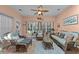 Inviting sunroom with wicker furniture, tile floors, and lots of natural light at 77 Redwing Ct., Pawleys Island, SC 29585