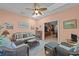 Cozy sunroom boasts wicker furniture, tile floors, and natural lighting at 77 Redwing Ct., Pawleys Island, SC 29585