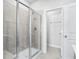 Primary bathroom featuring glass enclosed shower with tile surround and a towel rack at 8253 Vibrant Loop, Longs, SC 29568