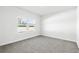 Bright bedroom with neutral carpet and large windows letting in natural light at 8253 Vibrant Loop, Longs, SC 29568