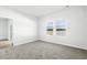 Bedroom featuring neutral carpet and a large window overlooking the outdoor scenery at 8253 Vibrant Loop, Longs, SC 29568