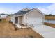 Charming single-Gathering home featuring a two-car garage, well-maintained lawn and quaint landscaping at 8253 Vibrant Loop, Longs, SC 29568
