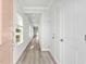 Bright hallway with neutral paint, trim, doors, and views towards the rest of the living space at 8253 Vibrant Loop, Longs, SC 29568