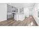 Bright, open kitchen with gray cabinets, stainless steel appliances, and a large center island at 8253 Vibrant Loop, Longs, SC 29568