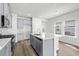 Well-lit kitchen features stainless appliances, modern gray cabinets and a center island with seating at 8253 Vibrant Loop, Longs, SC 29568