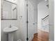 Clean bathroom with white pedestal sink and a view towards the stairwell at 861 Murray Ave., Myrtle Beach, SC 29577