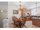 Dining area with a wood table, chandelier, and updated kitchen with stainless steel appliances at 861 Murray Ave., Myrtle Beach, SC 29577