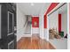 Bright foyer features hardwood floors, a staircase with carpet runner, and red accent wall at 861 Murray Ave., Myrtle Beach, SC 29577