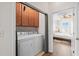 Laundry room with washer, dryer, and cabinets that leads into the bedroom at 861 Murray Ave., Myrtle Beach, SC 29577