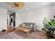 Bright living room with hardwood floors, ceiling fan, large couch, and plants at 861 Murray Ave., Myrtle Beach, SC 29577