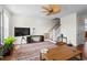 Bright living room with hardwood floors, ceiling fan, large couch, and a modern TV at 861 Murray Ave., Myrtle Beach, SC 29577