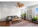 Bright living room with hardwood floors, ceiling fan, large couch, and many plants at 861 Murray Ave., Myrtle Beach, SC 29577