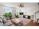 Bright living room with hardwood floors, ceiling fan, large couch, and a modern TV at 861 Murray Ave., Myrtle Beach, SC 29577