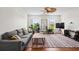 Bright living room with hardwood floors, ceiling fan, large couch, and a modern TV at 861 Murray Ave., Myrtle Beach, SC 29577