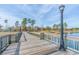 Scenic wooden pier with a black lamppost overlooking a tranquil lake and green trees at 861 Murray Ave., Myrtle Beach, SC 29577