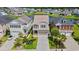 Aerial view of a two-story home with manicured landscaping next to a pond in a residential neighborhood at 873 Crystal Water Way, Myrtle Beach, SC 29579