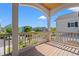 Spacious balcony with wooden floor and columns overlooking street with neighborhood views at 873 Crystal Water Way, Myrtle Beach, SC 29579