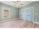 Neutral bedroom showcasing a window for natural light and blue closet doors at 873 Crystal Water Way, Myrtle Beach, SC 29579
