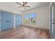 Bedroom with two closets, two windows, wood floors, a ceiling fan, and white walls at 873 Crystal Water Way, Myrtle Beach, SC 29579