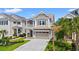 Two-story home with a covered porch, two-car garage, and a beautifully landscaped front yard at 873 Crystal Water Way, Myrtle Beach, SC 29579