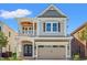 Charming two-story home featuring a front porch, a two car garage, and stylish architectural details at 873 Crystal Water Way, Myrtle Beach, SC 29579