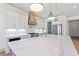 Gourmet kitchen with a large marble island, stainless steel appliances, and white cabinets at 873 Crystal Water Way, Myrtle Beach, SC 29579