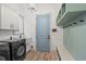 This laundry room features a side-by-side washer and dryer, storage and counter space at 873 Crystal Water Way, Myrtle Beach, SC 29579