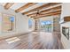 Bright living room with a beamed ceiling, fireplace, built-in shelving, and sliding glass door at 873 Crystal Water Way, Myrtle Beach, SC 29579