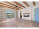 Bright living room with wood beam ceilings, fireplace, and sliding glass doors to a balcony with a lake view at 873 Crystal Water Way, Myrtle Beach, SC 29579