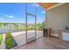Screened patio with brick outdoor kitchen, mini refrigerator, and views of a serene lake at 873 Crystal Water Way, Myrtle Beach, SC 29579