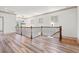 Second story featuring wood look flooring, wood banister and railing, and natural light at 873 Crystal Water Way, Myrtle Beach, SC 29579