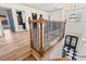 Second story features wood-look flooring, wood banister and railing with a view of the front door at 873 Crystal Water Way, Myrtle Beach, SC 29579