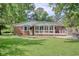 View of the home's backyard featuring a patio, sunroom, well-manicured lawn, and privacy fence at 900 47Th Ave. N, Myrtle Beach, SC 29577