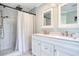 Modern bathroom featuring a double sink vanity and tiled shower with dual shower heads at 900 47Th Ave. N, Myrtle Beach, SC 29577