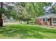 Charming brick home featuring mature trees, a well-manicured lawn, and neighborhood street view at 900 47Th Ave. N, Myrtle Beach, SC 29577