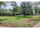 Wide shot of front yard showing well-maintained lawn, mature trees, and a peaceful setting at 900 47Th Ave. N, Myrtle Beach, SC 29577