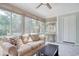 Bright sunroom featuring neutral colored furniture, large windows, and a ceiling fan at 900 47Th Ave. N, Myrtle Beach, SC 29577