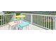 Balcony has a table and colorful chairs offering views of the scenic area at 92 High Hammock Way, Pawleys Island, SC 29585