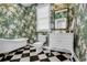 Stylish bathroom with floral wallpaper, black and white tile floor, and claw foot tub at 92 High Hammock Way, Pawleys Island, SC 29585