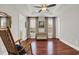 Spacious bedroom with ensuite access features two windows and wood floors at 92 High Hammock Way, Pawleys Island, SC 29585