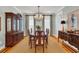 This formal dining area features a china cabinet, chandelier, and bright windows at 92 High Hammock Way, Pawleys Island, SC 29585