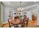 Formal dining room features a wood table, chandelier, and views into the kitchen at 92 High Hammock Way, Pawleys Island, SC 29585