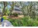Multi-story house with decks, brick columns, and lush landscaping at 92 High Hammock Way, Pawleys Island, SC 29585