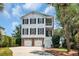 Charming two-story home with brick accents, double garage, and a welcoming staircase leading to a cozy balcony at 92 High Hammock Way, Pawleys Island, SC 29585