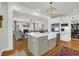 Modern kitchen with a central island, stainless steel appliances, and open layout to the living room, great for gatherings at 92 High Hammock Way, Pawleys Island, SC 29585