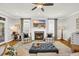 Cozy living room featuring a brick fireplace, plush seating, and ample natural light, perfect for relaxation at 92 High Hammock Way, Pawleys Island, SC 29585