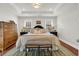 Relaxing main bedroom featuring tray ceilings, neutral walls, and warm wood flooring at 92 High Hammock Way, Pawleys Island, SC 29585